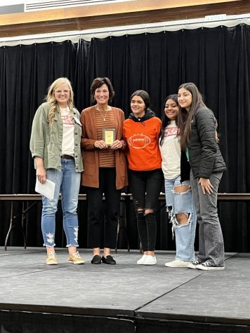 After a tear-inducing speech from Lexington High School Adviser, Erica Brockmoller, Lexington Principal Audrey Downey accepts the first NHSPA Administrator of the Year award with student journalists along side her. 